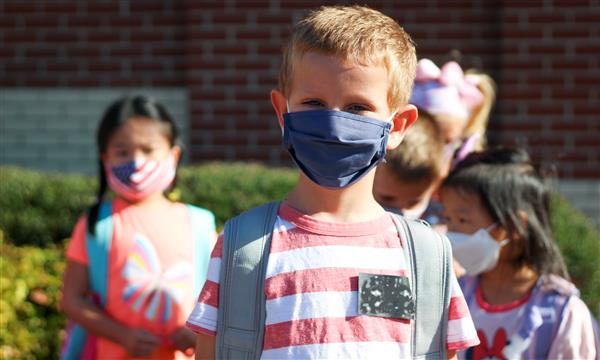 students smile while wearing mask